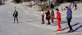 Movie still from “For Your Eyes Only” (1981), directed by John Glen – A group of people standing on top of a snow covered slope; Wide shot, High angle