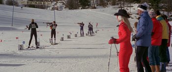 Movie still from “For Your Eyes Only” (1981), directed by John Glen – A group of skiers are lined up in the snow; Wide shot, Over the shoulder angle