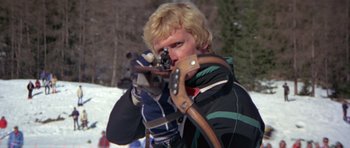 Movie still from “For Your Eyes Only” (1981), directed by John Glen – A man holding a pair of skis in his hands; Close Up shot, Low angle