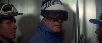 Movie still from “For Your Eyes Only” (1981), directed by John Glen – A man wearing ski goggles and a blue jacket; Close Up shot, Over the shoulder angle