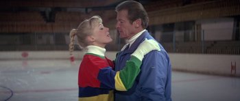 Movie still from “For Your Eyes Only” (1981), directed by John Glen – A man and a girl are hugging on the ice; Medium shot, Over the shoulder angle