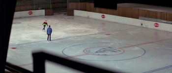 Movie still from “For Your Eyes Only” (1981), directed by John Glen – A man standing on a rink in a building; Extreme Wide shot, High angle