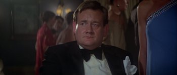 Movie still from “For Your Eyes Only” (1981), directed by John Glen – A person wearing a suit and tie; Close Up shot, Low angle