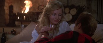Movie still from “For Your Eyes Only” (1981), directed by John Glen – A woman holding a wine glass in her hand; Close Up shot, Over the shoulder angle
