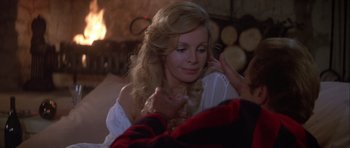 Movie still from “For Your Eyes Only” (1981), directed by John Glen – A woman in a white dress is holding her hand out to a man; Close Up shot, Over the shoulder angle