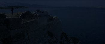 Movie still from “For Your Eyes Only” (1981), directed by John Glen – A truck is on top of a cliff at night; Extreme Wide shot, High angle