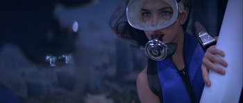 Movie still from “For Your Eyes Only” (1981), directed by John Glen – A woman with a gas mask on her face; Close Up shot, Low angle