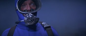 Movie still from “For Your Eyes Only” (1981), directed by John Glen – A man in a scuba diving suit and helmet; Close Up shot, Overhead angle