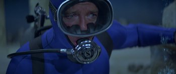 Movie still from “For Your Eyes Only” (1981), directed by John Glen – A man in a scuba suit with a mask on his face; Close Up shot, High angle