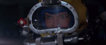 Movie still from “For Your Eyes Only” (1981), directed by John Glen – A woman is looking into a mirror in a diving suit; Close Up shot, Low angle