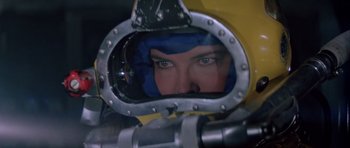 Movie still from “For Your Eyes Only” (1981), directed by John Glen – A woman looking into the reflection of herself in a mirror; Close Up shot, Low angle