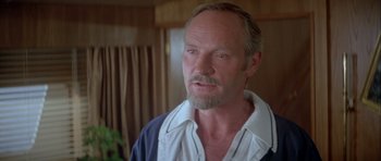 Movie still from “For Your Eyes Only” (1981), directed by John Glen – A person with a beard; Close Up shot, Over the shoulder angle