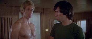 Movie still from “For Your Eyes Only” (1981), directed by John Glen – Two men standing next to each other in a room; Medium shot, Low angle