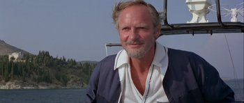Movie still from “For Your Eyes Only” (1981), directed by John Glen – A person on a boat with trees in the background; Close Up shot, Low angle