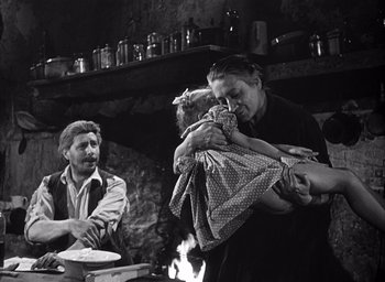 Movie still from “Forbidden Games” (1952), directed by René Clément – An old photo of a woman holding a child; Medium shot, Over the shoulder angle