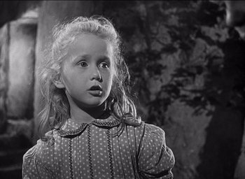 Movie still from “Forbidden Games” (1952), directed by René Clément – A little girl in a polka dot dress looking at the camera; Close Up shot, Low angle