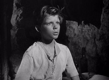 Movie still from “Forbidden Games” (1952), directed by René Clément – A young boy is looking into the distance; Close Up shot, High angle