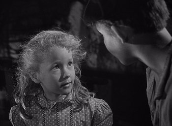 Movie still from “Forbidden Games” (1952), directed by René Clément – A little girl is looking up at an older woman; Close Up shot, Over the shoulder angle