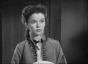 Movie still from “Fort Apache” (1948), directed by John Ford – A black and white photo of a woman in a dress; Close Up shot, High angle