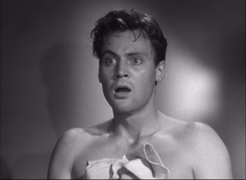 Movie still from “Fort Apache” (1948), directed by John Ford – A black and white photo of a man with a towel around his neck; Close Up shot, Low angle