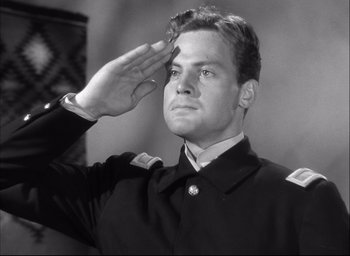 Movie still from “Fort Apache” (1948), directed by John Ford – A black and white photo of a man saluting; Medium shot, Low angle