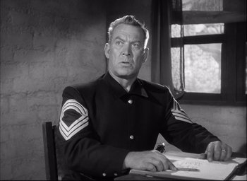 Movie still from “Fort Apache” (1948), directed by John Ford – An old photo of a man in a uniform sitting at a table; Close Up shot, Low angle
