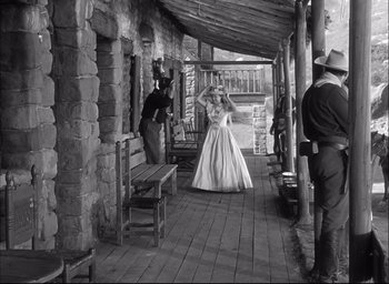 Movie still from “Fort Apache” (1948), directed by John Ford – An old photo of a woman in a white dress; Wide shot, Over the shoulder angle