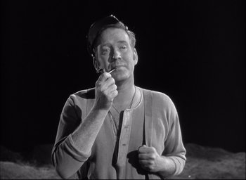 Movie still from “Fort Apache” (1948), directed by John Ford – An old photo of a man smoking a cigarette; Medium shot, Low angle