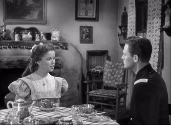 Movie still from “Fort Apache” (1948), directed by John Ford – A man and a woman sitting at a dining table; Medium shot, Over the shoulder angle