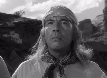 Movie still from “Fort Apache” (1948), directed by John Ford – A man with long blonde hair and a bandana around his neck; Close Up shot, Low angle