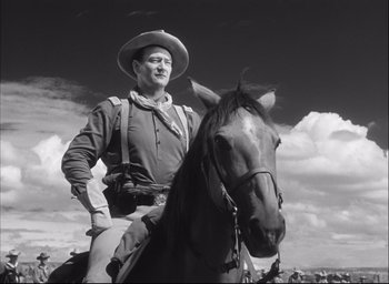 Movie still from “Fort Apache” (1948), directed by John Ford – A man is sitting on top of a horse; Medium shot, Low angle