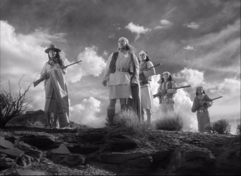 Movie still from “Fort Apache” (1948), directed by John Ford – A black and white photo of a group of people standing on top of a hill; Wide shot, Low angle