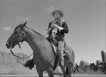 Movie still from “Fort Apache” (1948), directed by John Ford – A man riding on the back of a brown horse; Medium shot, Low angle