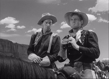 Movie still from “Fort Apache” (1948), directed by John Ford – Two men on horseback looking at a camera; Medium shot, Low angle