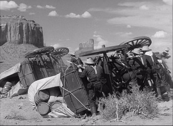 Movie still from “Fort Apache” (1948), directed by John Ford – A black and white photo of a group of people in the desert; Wide shot, Low angle
