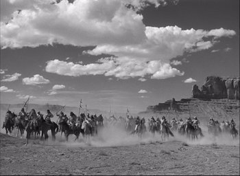 Movie still from “Fort Apache” (1948), directed by John Ford – A black and white photo of a group of people on horses; Extreme Wide shot, Low angle