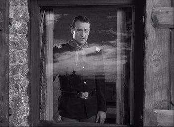 Movie still from “Fort Apache” (1948), directed by John Ford – A black and white photo of a man in a military uniform; Medium shot, Low angle