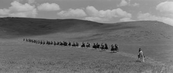 Movie still from “Forty Guns” (1957), directed by Samuel Fuller – A black and white photo of people on horseback in a field; Extreme Wide shot, High angle