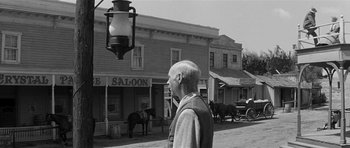 Movie still from “Forty Guns” (1957), directed by Samuel Fuller – An older man standing on the side of the street; Wide shot, Low angle