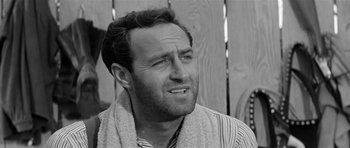 Movie still from “Forty Guns” (1957), directed by Samuel Fuller – Black and white photograph of a man with a towel around his neck; Close Up shot, Low angle