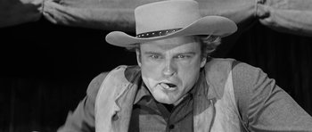 Movie still from “Forty Guns” (1957), directed by Samuel Fuller – A man in a cowboy hat and a jacket; Close Up shot, Low angle