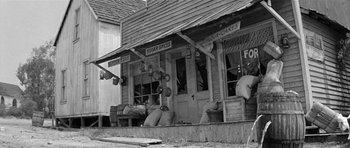 Movie still from “Forty Guns” (1957), directed by Samuel Fuller – An old photo of a store front in a small town; Wide shot, Low angle