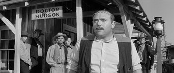 Movie still from “Forty Guns” (1957), directed by Samuel Fuller – A black and white photo of a man with a mustache; Medium shot, Low angle