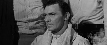 Movie still from “Forty Guns” (1957), directed by Samuel Fuller – A man with a towel around his neck; Close Up shot, Over the shoulder angle