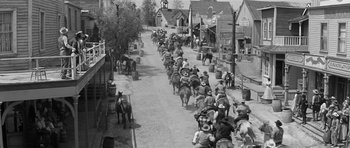 Movie still from “Forty Guns” (1957), directed by Samuel Fuller – A black and white photo of a parade of people on horses; Extreme Wide shot, High angle