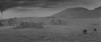 Movie still from “Forty Guns” (1957), directed by Samuel Fuller – A black - and - white photo of a grassy field; Extreme Wide shot, Low angle