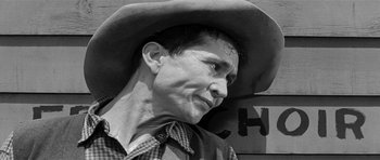 Movie still from “Forty Guns” (1957), directed by Samuel Fuller – A black and white photo of a man wearing a cowboy hat; Close Up shot, Low angle