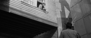 Movie still from “Forty Guns” (1957), directed by Samuel Fuller – An old photo of a man looking out of a window; Wide shot, Low angle