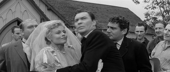 Movie still from “Forty Guns” (1957), directed by Samuel Fuller – An old photo of a man and a woman getting married; Medium shot, Over the shoulder angle