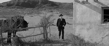 Movie still from “Forty Guns” (1957), directed by Samuel Fuller – A black and white photo of a man in a cowboy hat; Wide shot, Low angle